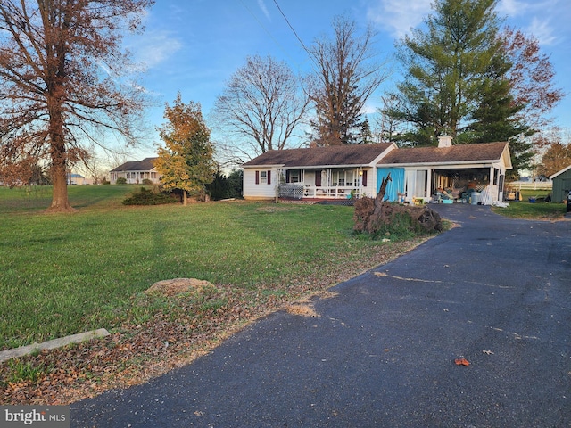 2315 Table Rock Rd, Biglerville, PA 17307 - view of front of property with covered porch, asphalt driveway, a front yard, and a chimney