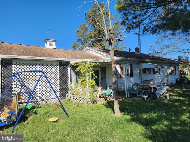 back of property featuring a yard