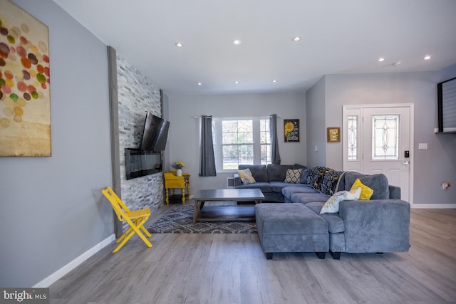 living room featuring a wealth of natural light and light hardwood / wood-style flooring