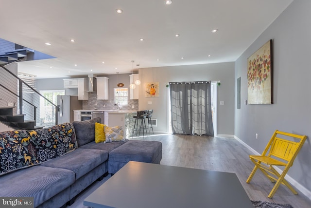 living room with light wood-type flooring and sink