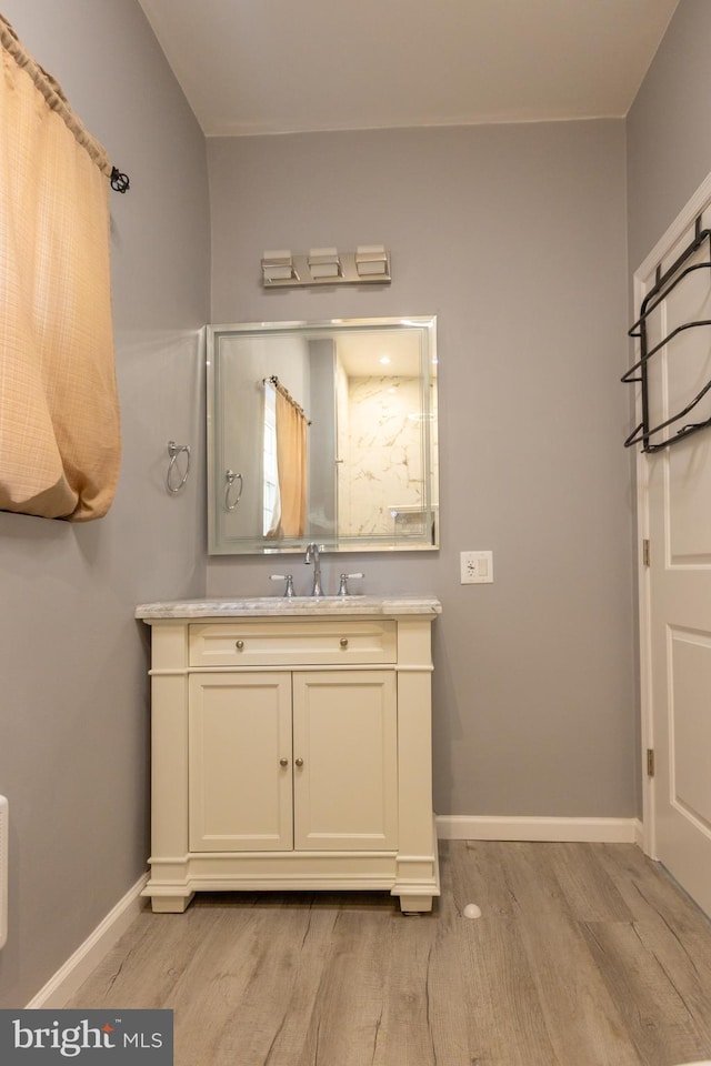 bathroom with hardwood / wood-style floors and vanity