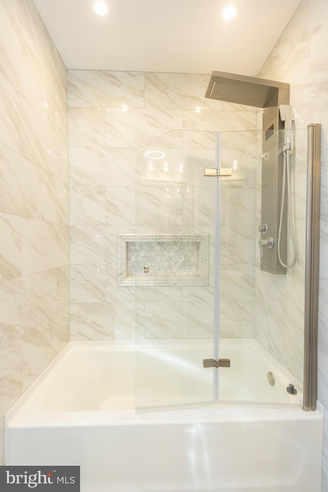 bathroom featuring bath / shower combo with glass door