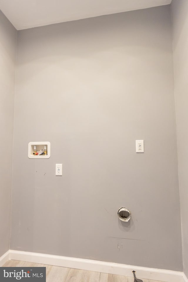 washroom featuring hookup for a washing machine and light hardwood / wood-style flooring