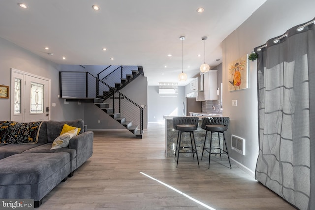 living room featuring a healthy amount of sunlight and light wood-type flooring