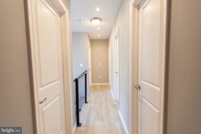 corridor with light hardwood / wood-style floors