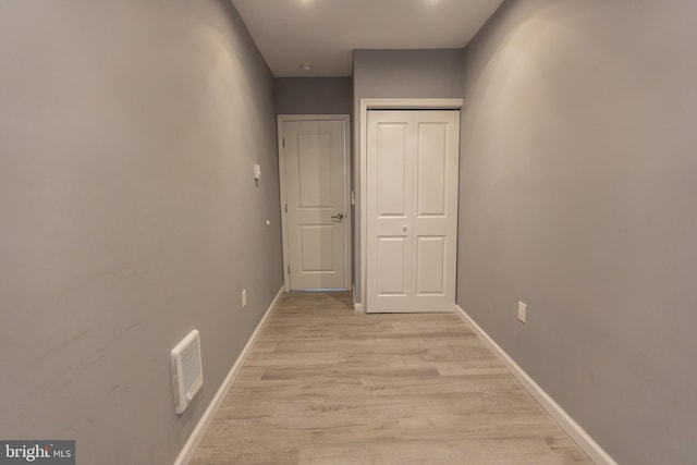 corridor with light hardwood / wood-style flooring