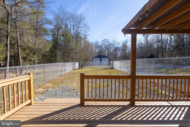 wooden terrace with a lawn and an outdoor structure