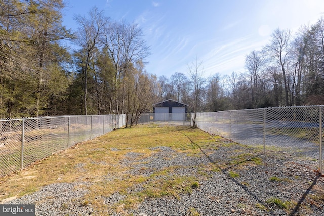 view of yard featuring a garage and an outdoor structure