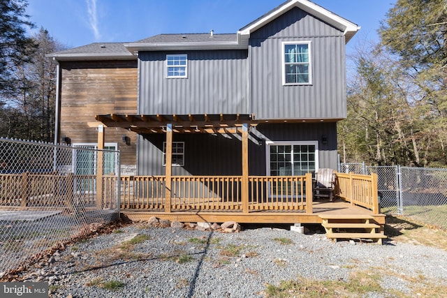 back of property featuring a wooden deck