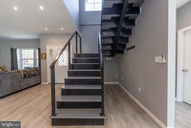 stairs featuring hardwood / wood-style flooring