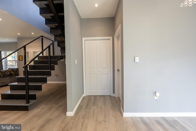 stairs featuring a high ceiling and wood-type flooring