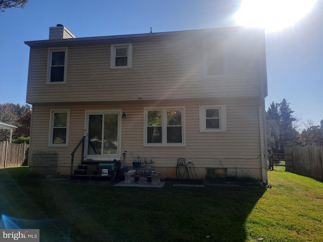 back of house with a yard and a patio area