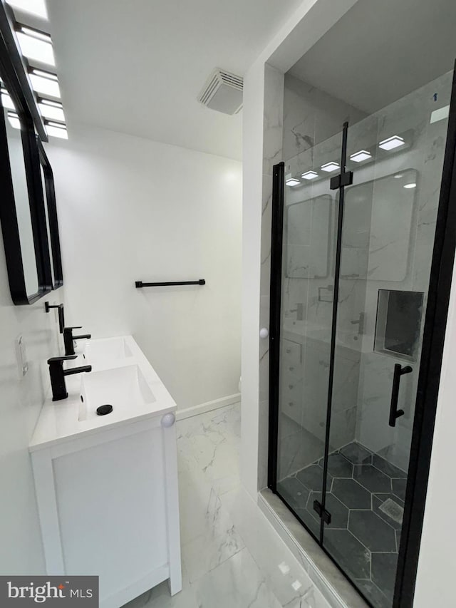 bathroom featuring vanity and a shower with door