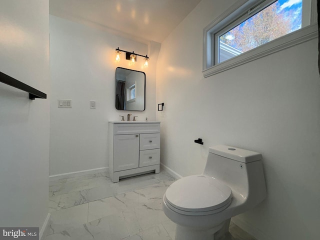 bathroom featuring marble look tiles, baseboards, toilet, and vanity