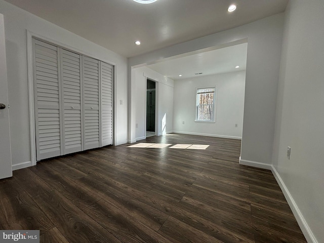 unfurnished bedroom featuring dark hardwood / wood-style flooring