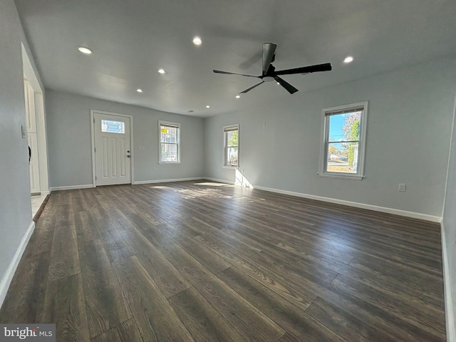 interior space with ceiling fan, a healthy amount of sunlight, and dark hardwood / wood-style flooring