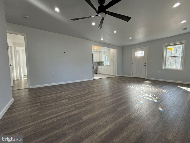 unfurnished living room with baseboards, recessed lighting, a ceiling fan, and dark wood-style floors