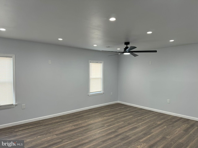 unfurnished room with ceiling fan and dark wood-type flooring