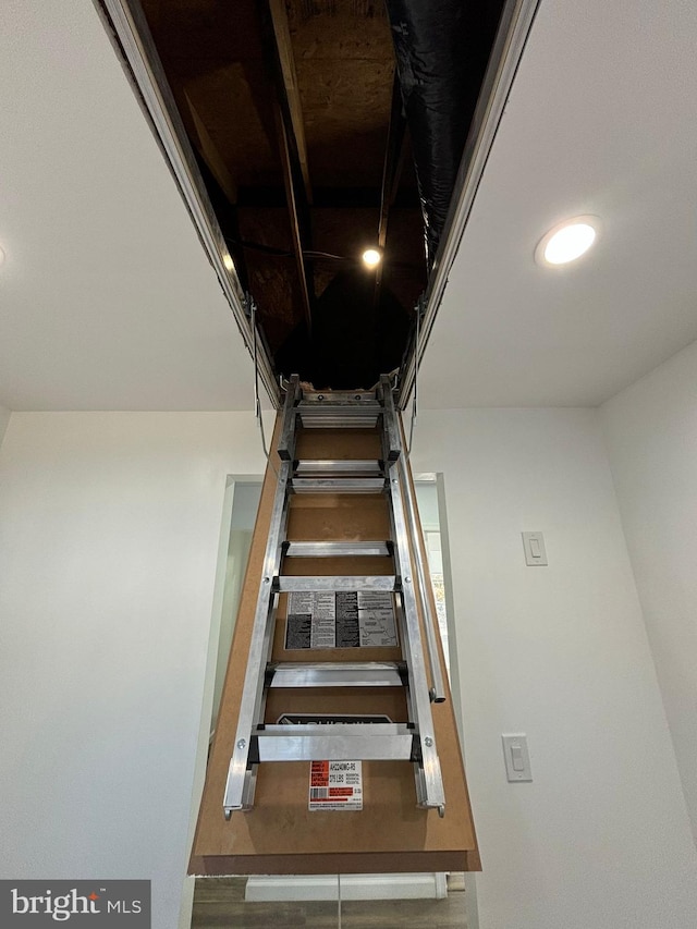 stairway with hardwood / wood-style floors