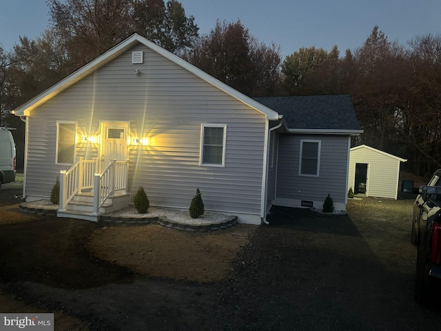 back of property with a shingled roof