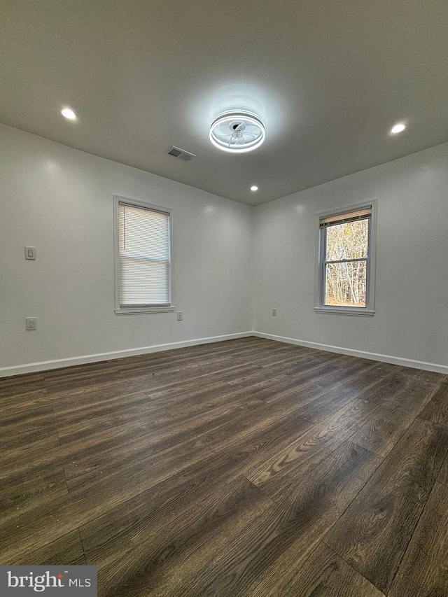 empty room featuring dark hardwood / wood-style flooring