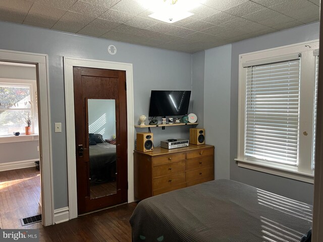 bedroom with visible vents and dark wood finished floors