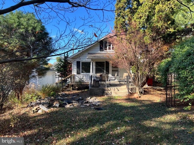 rear view of house with a lawn and a patio area