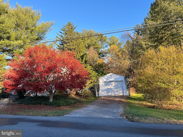 exterior space featuring a garage, an outbuilding, and driveway