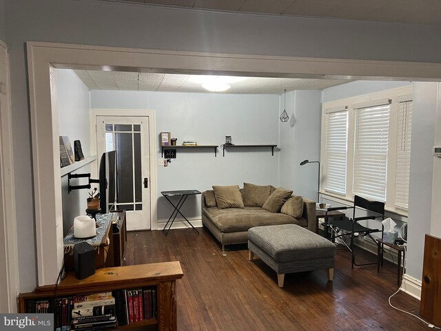 living room featuring baseboards and wood finished floors