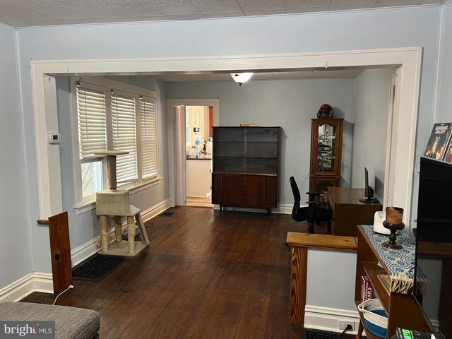 interior space featuring baseboards and hardwood / wood-style flooring