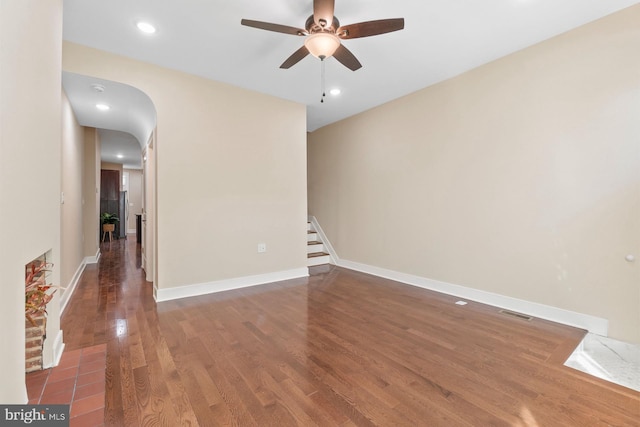 empty room with dark wood-type flooring and ceiling fan