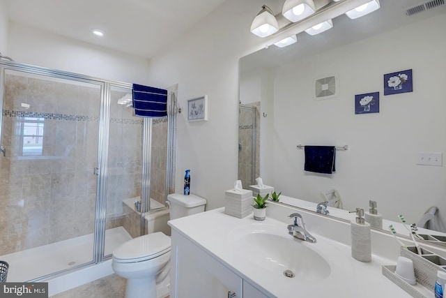 bathroom with walk in shower, vanity, and toilet