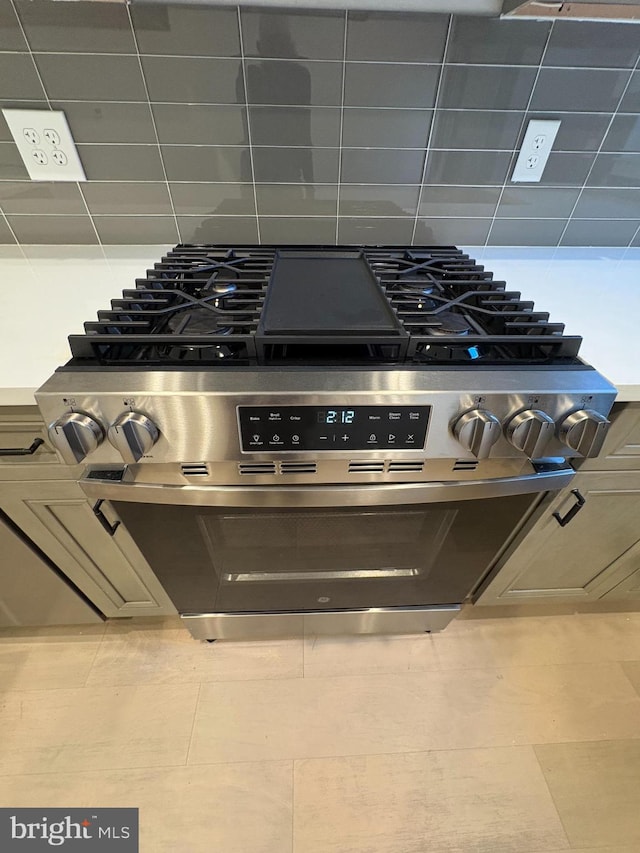 room details with tile patterned floors and stainless steel range