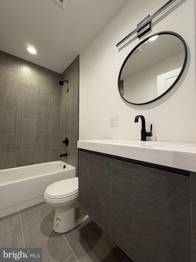 full bathroom with tile patterned floors, vanity, toilet, and tiled shower / bath