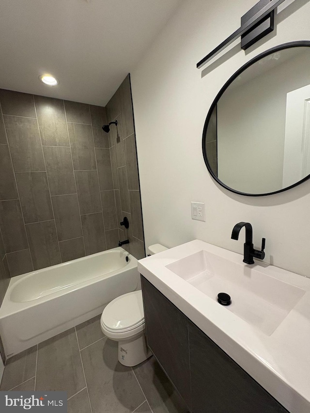 full bathroom featuring tile patterned flooring, vanity, tiled shower / bath combo, and toilet