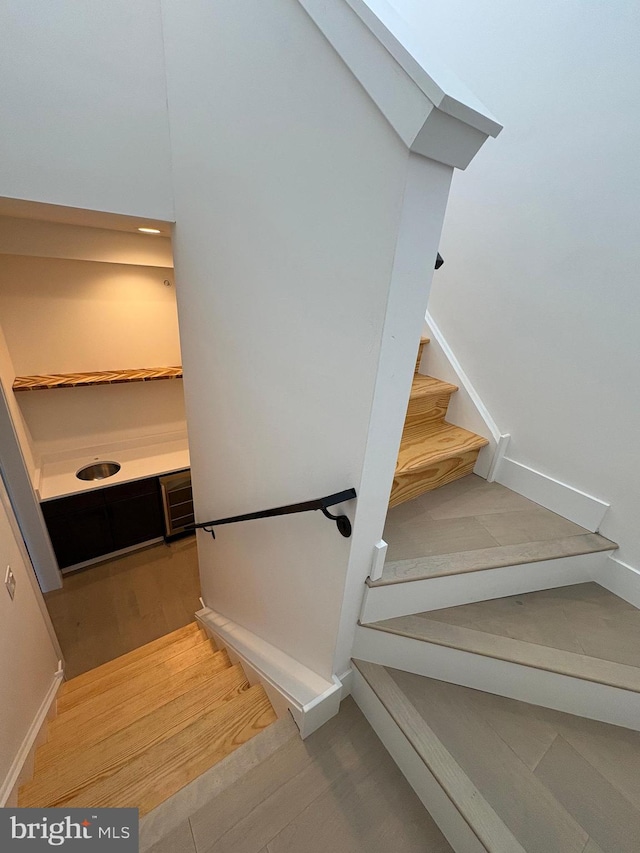 staircase featuring wood-type flooring