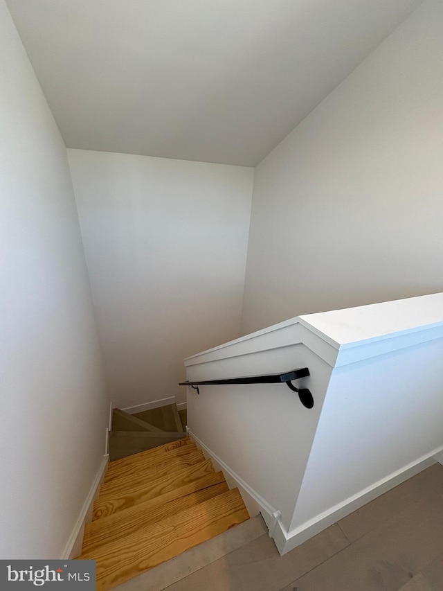 staircase with hardwood / wood-style floors