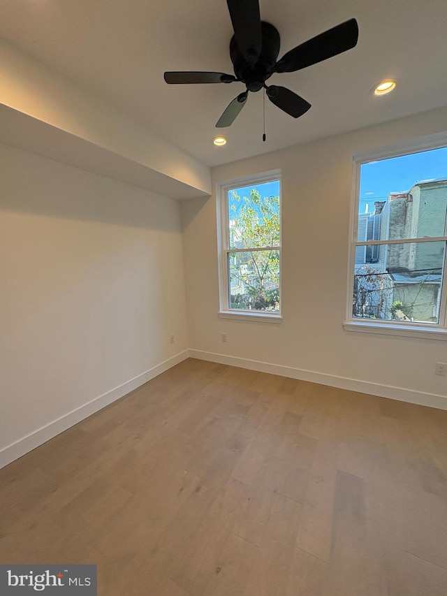 spare room with hardwood / wood-style flooring and ceiling fan