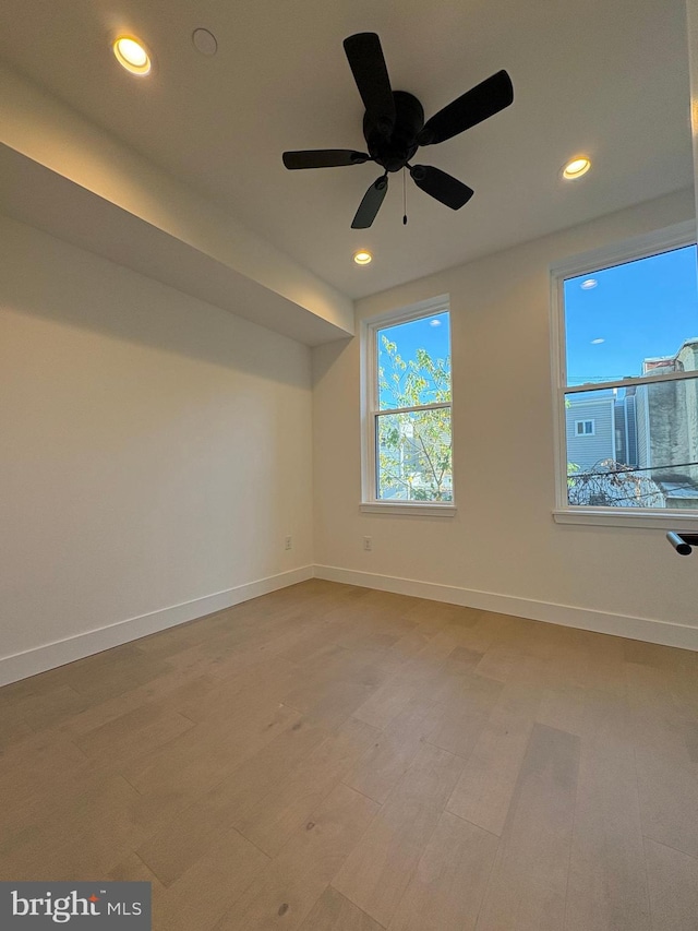 spare room featuring wood-type flooring and ceiling fan