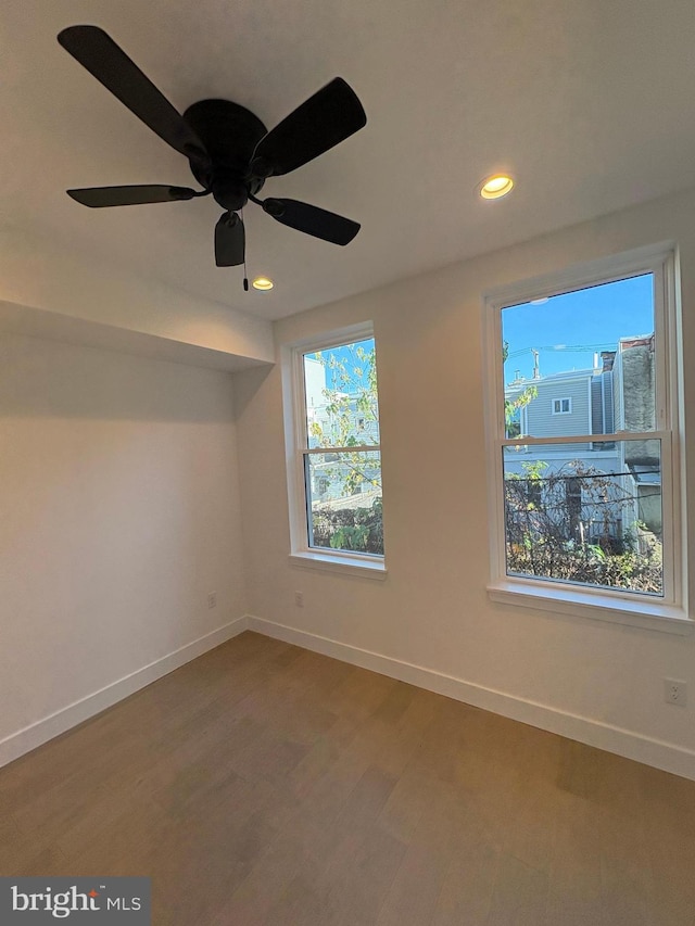 spare room with hardwood / wood-style flooring and ceiling fan