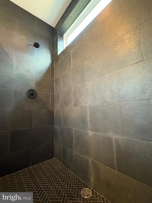 bathroom with tiled shower