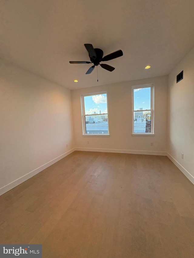 spare room featuring ceiling fan and hardwood / wood-style flooring