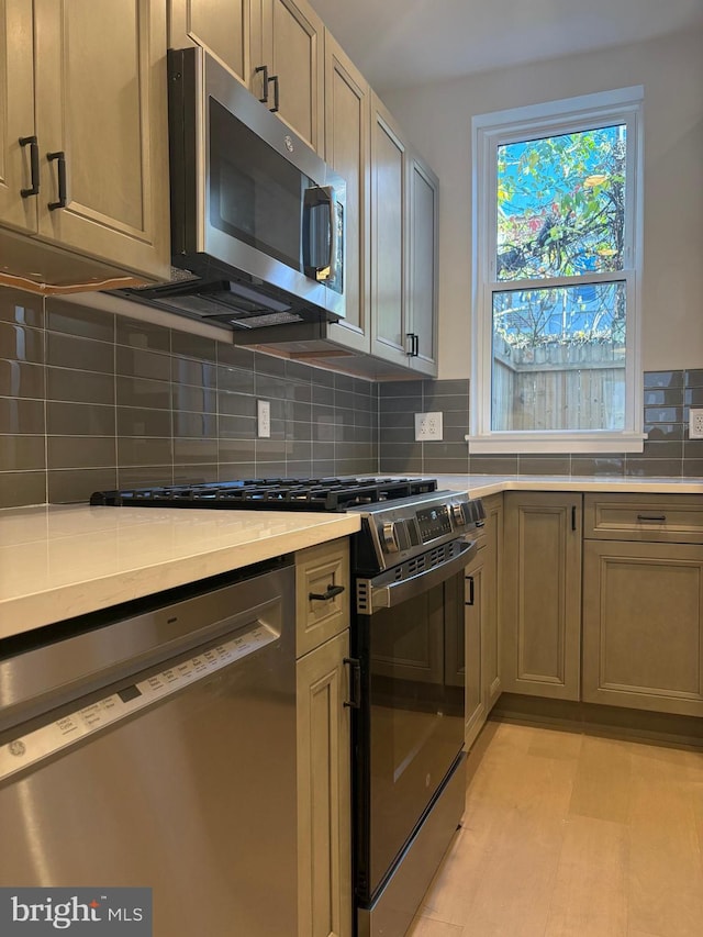 kitchen with decorative backsplash and stainless steel appliances