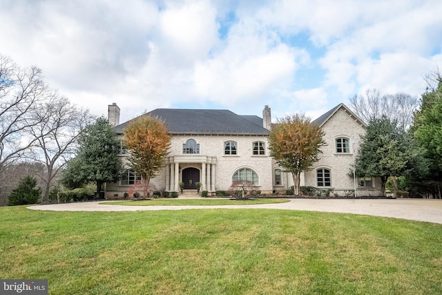 rear view of property with a lawn