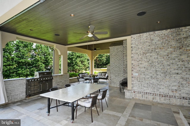 view of patio with ceiling fan and an outdoor kitchen