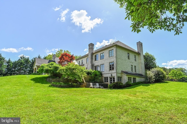 view of side of property with a lawn