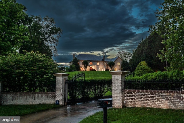 gate at dusk with a lawn