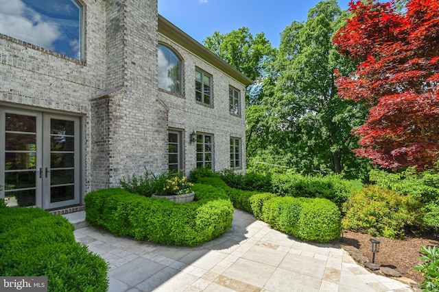 entrance to property with a patio area and french doors