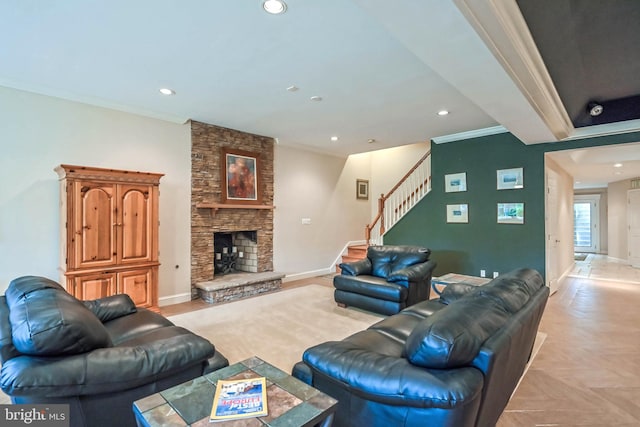 living room with a stone fireplace, crown molding, and light parquet floors