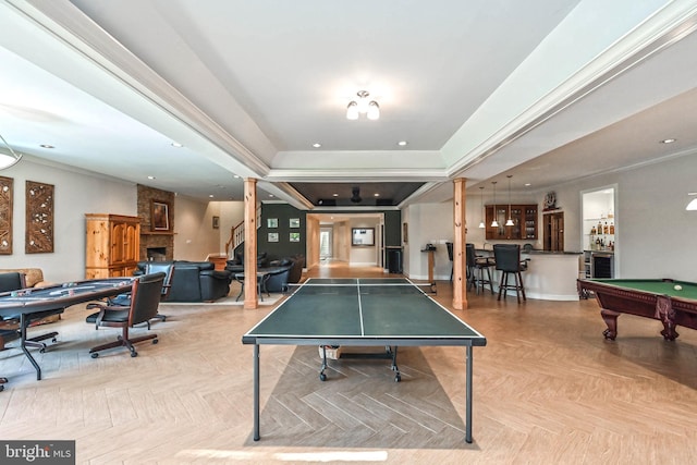 game room featuring bar, a fireplace, light parquet floors, and pool table